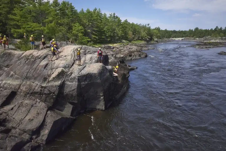 cliff jumping on whitewater rafting trip with Wilderness Tours